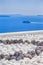 Travel Destinations. Ferry Floating In Front Art Stones in Oia Village in Santorini