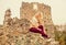 Travel destinations. Woman makeup face sit on stony ruins background defocused. Tourism concept. Explore midcentury