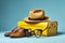 Travel essentials suitcase with straw hat, sunglasses, passport, and slippers on blue background