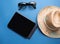 Travel Flatlay accessories Blue topview with sunglasses hat and map, for holidays vacation summer concept.