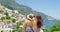 Travel, friends and women with phone in Italy taking pictures of city landscape by ocean, sea and mountain. Summer