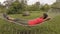 Travel on Galapagos Islands - tourist relaxing in hammock by Giant Tortoise