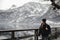 Travel girl with a backpack enjoying the magnificent snowy mountain in village of Hallstatt with Lake Hallstadt in winter. Travel