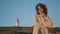 Travel girl posing green hill lighthouse. Calm curly woman resting sunlight