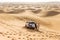 Travel guide men with four wheel drive car on the great desert at Dubai