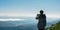 Travel hiker taking photo of majestic mountains range panorama. Carpathian mountains, Ukraine, Europe. Travel background,