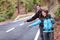 Travel hikers couple hitchhiking on road trip