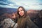 Travel hiking selfie photo of young beautiful teenager student at Grand Canyon viewpoint in Arizona