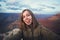 Travel hiking selfie photo of young beautiful teenager student at Grand Canyon viewpoint in Arizona