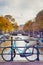 Travel Ideas. City of Amsterdam. Traditional Dutch Bicycle In Front of The Canal Fence in Amsterdam