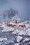 Travel Ideas. Famous Tourist Attraction Hamnoy Fishing Village At Lofoten Islands in Norway. Line of Red Rorbu Houses at Winter