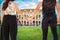 Travel in Italy Rome, Colosseum. Engaged couple tourists walking hand by hand in the historic center of the city, seen from behind