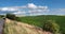 Travel landscape in Europe countryside. Agricultural fields on hills by the road in Bohemia, Czesh Republic. Panoramic