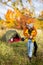 Travel, love and autumn concept - full length portrait of couple in love near green tent in autumn forest