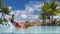 Travel luxury hotel swimming pool woman relaxing in chair on summer vacation