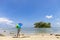 Travel man with colorful umbrella on the sand scenery island in