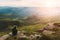 Travel man tourist sitting alone on the edge mountains over green valley adventure lifestyle extreme vacations green landscape