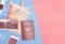 Travel objects accessories on blue pink background with passport camera and plane