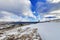 Travel photographer doing pictures in beautiful snow-covered rocks on a sunny day. Lofoten islands. Beautiful Norway landscape