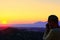 Travel photographer taking a photo of a valley at sunset