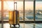 Travel-ready: Suitcase placed in front of airport windows