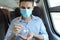 Travel safely on public transport. Business man with surgical mask using wash hand sanitizer gel dispenser. Passenger with