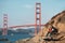 Travel in San Francisco, tourist man with camera in front of Golden Gate Bridge, San Francisco, California, USA