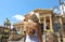 Travel in Sicily. Back view of beautiful woman visiting Teatro Massimo opera house in Palermo, Italy