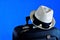 Travel-suitcase, sunglasses and white hat on creative blue background. Travel to the tropical beach world of leisure or cruise