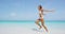 Travel sun beach vacation woman happy blissful running on beach in bikini joyful