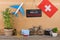 Travel time - blackboard with text & x22;Love switzerland& x22;, flag of the switzerland, airplane model, camera, bicycle