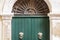 Travel to Italy - historical street of Catania, Sicily, entrance door of old building with knockers