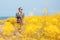 Travel to Jeju Island, South Korea, a young girl tourist walks on the background of blooming fields