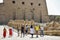 Travel tour group goes to Karnak Temple. Beautiful Egyptian landmark with hieroglyphics, decayed temples, obelisks and other