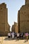 Travel tour group goes to Karnak Temple. Beautiful Egyptian landmark with hieroglyphics, decayed temples, obelisks and other