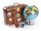 Travel or tourism concept. Old suitcase with stickers, globe