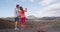 Travel tourist couple taking photo using phone in volcano mountains of Lanzarote