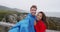 Travel tourist couple taking selfie video by Punakaiki Pancake Rocks New Zealand