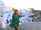 Travel tourist happy woman climbs the stairs in Santorini, Cyclades Islands, Greece, Europe. Girl on summer vacation visiting