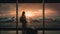 Travel tourist standing with luggage watching sunset at airport window. Unrecognizable woman looking at lounge looking at