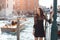 Travel tourist woman on pier against beautiful view on venetian chanal in Venice, Italy.