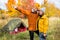 Travel, trekking and hiking concept - couple hikers near green tent in autumn forest