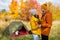 Travel, trekking and hiking concept - portrait of couple in love posing near green tent in autumn forest