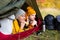 Travel, trekking and hiking concept - portrait of couple lying in tent in autumn forest