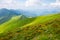 Travel, trekking, nature. Majestic, high green mountains. Horizontal frame