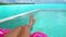 Travel vacation concept with bikini woman relaxing swimming in luxury infinity pool of Tahiti resort hotel lying in