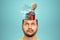 Travel, vacation concept. A creative image of a man in his head instead of a brain is suitcases, a samlet, sneakers and a balloon