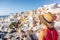 Travel vacation greece santorini woman tourist looking at Oia village view, luxury Europe destination holiday. Summer