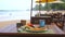 Travel, vacation, holiday concept. Beachside restaurant in tropical country, turquoise sea waves background. Table with
