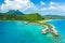 Travel vacation paradise aerial image with overwater bungalows in coral reef sea